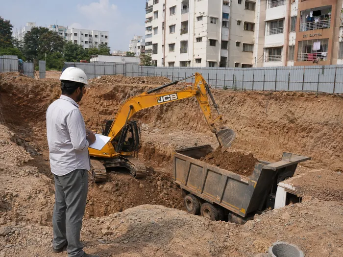 Supervisor inspecting excavation site